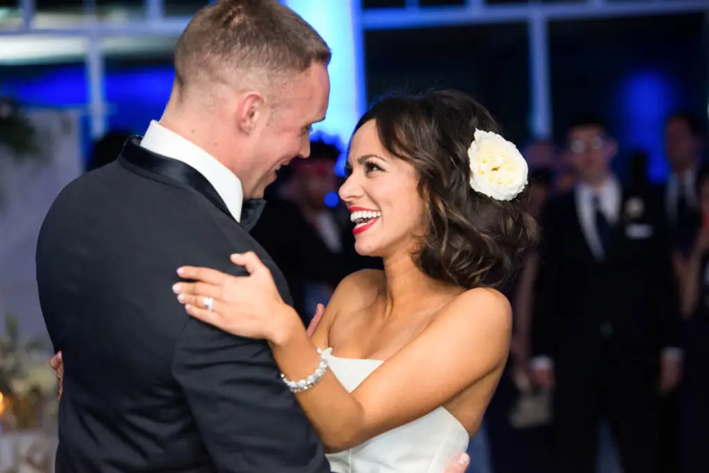Bride and groom sharing a romantic first dance, gazing into each other's eyes