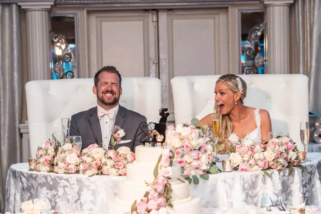 Bride and groom laughing during best man’s speech