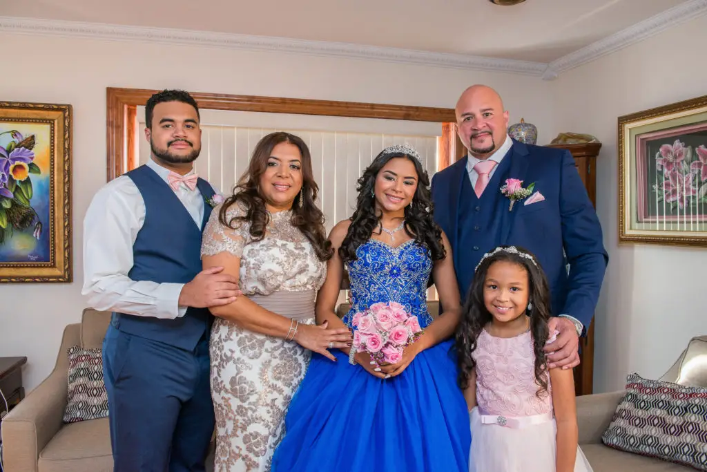 Birthday girl posing with family at Sweet 16 party