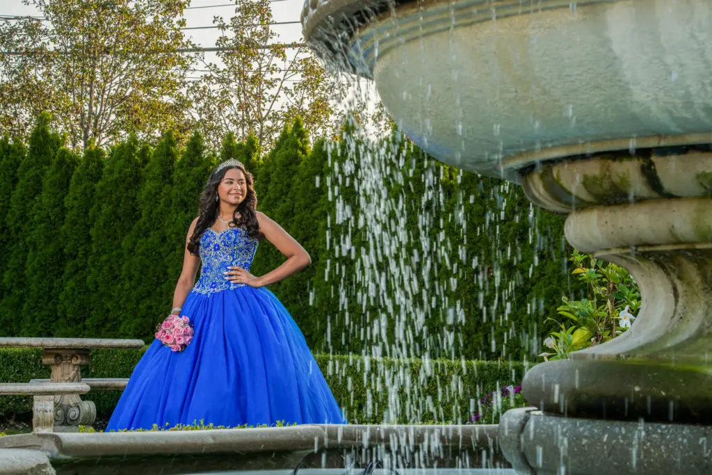Sweet 16 celebrant in elegant dress at Russo's On The Bay garden​