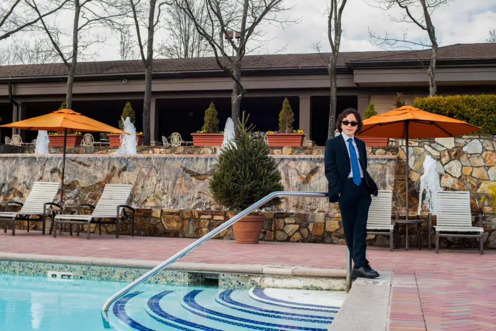 Bar Mitzvah boy's outdoor portrait by the pool at Crest Hollow Country Club​