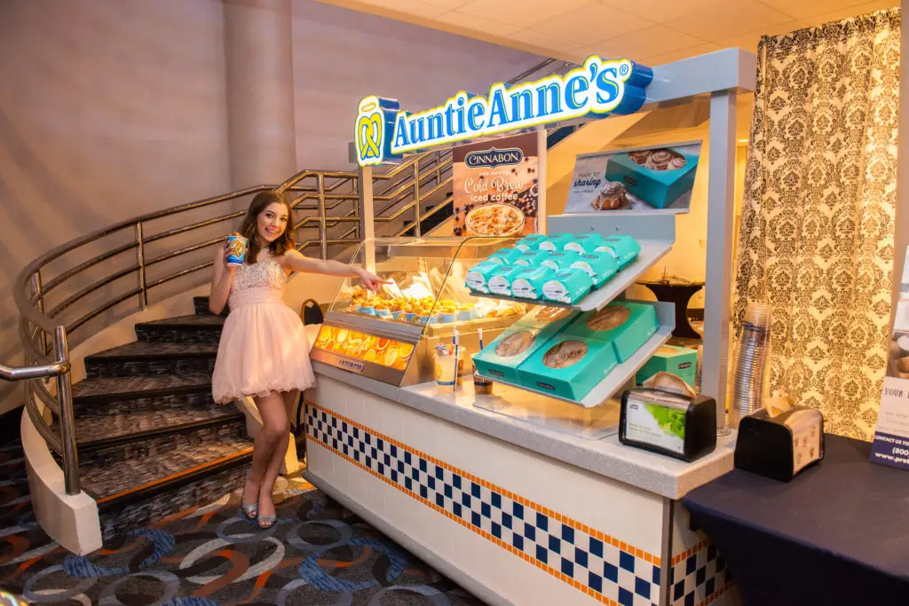 Pretzel lovers' dream! Sweet 16 girl posing with Auntie Anne’s setup