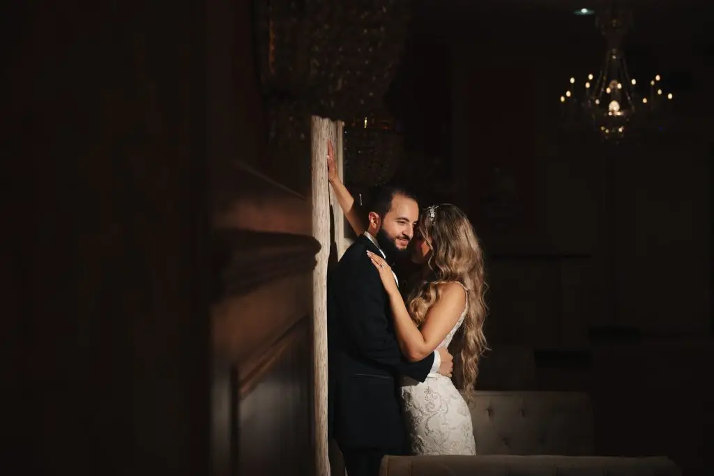 Bride and Groom Leaning Against Wall at Flora Terrace