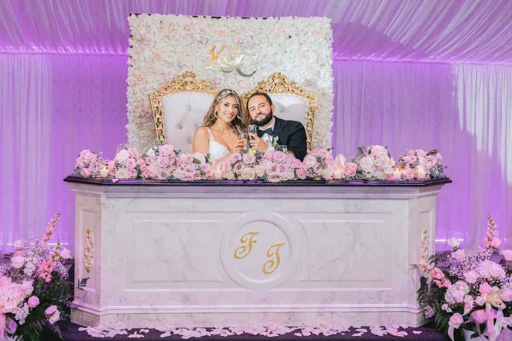 Bride and groom's intimate moment at their sweetheart table at Floral Terrace​