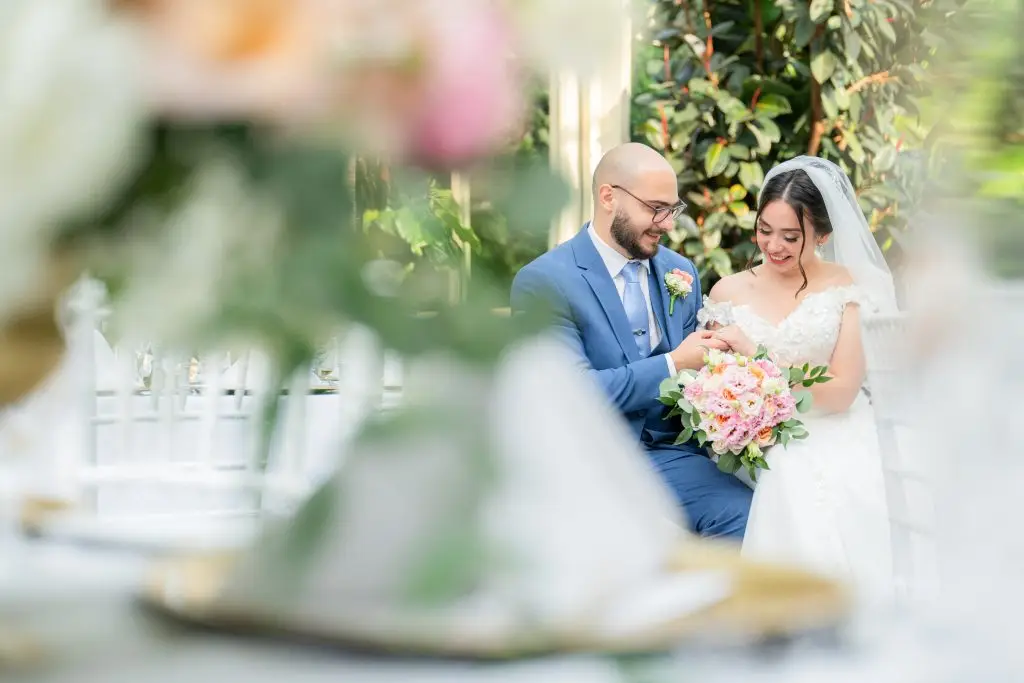 Bride and groom posing in Rare650's elegant Conservatory during wedding reception​