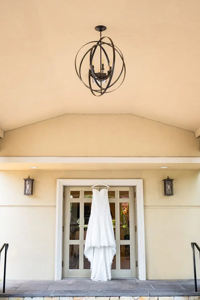 Bridal gown hanging in front of The Soundview door