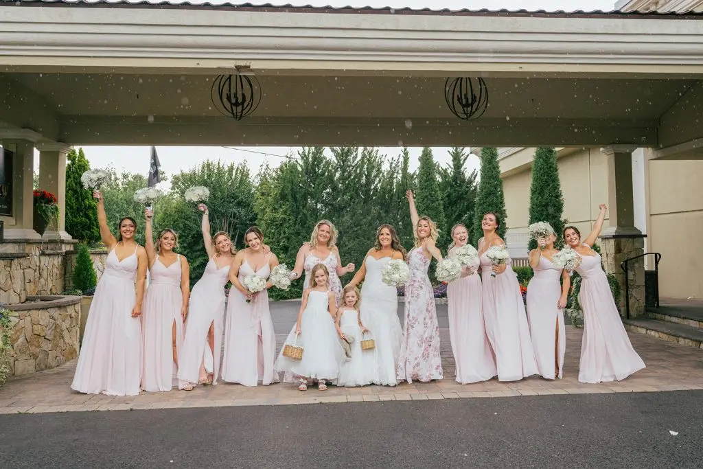 Bride laughing with bridesmaids in fun candid photo