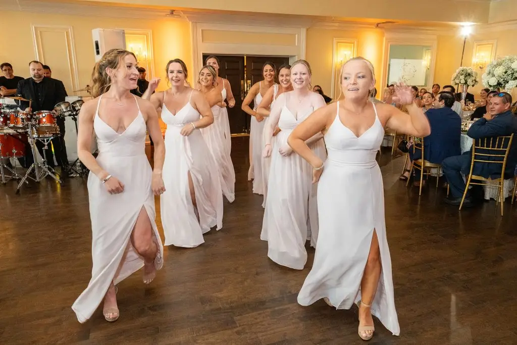 Bridesmaids make fun and elegant entrance at wedding reception