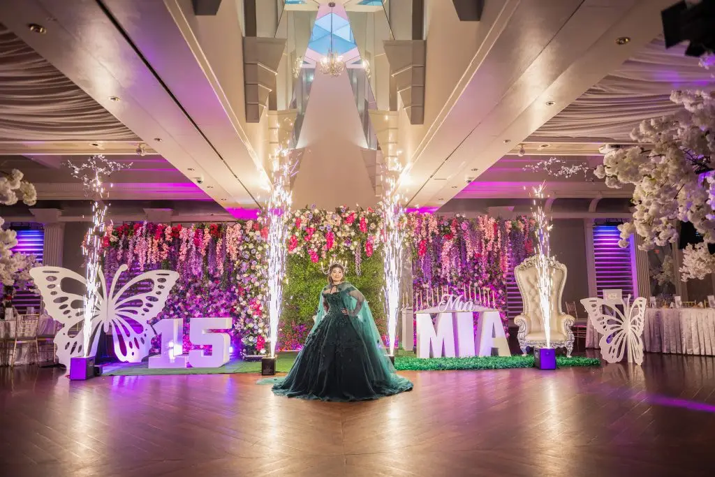 Quinceañera posing in elegant ballroom reception photographed by JS Visions Long Island