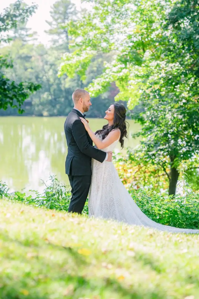 Bride and groom by the pond at The Hill, Hudson, NY​