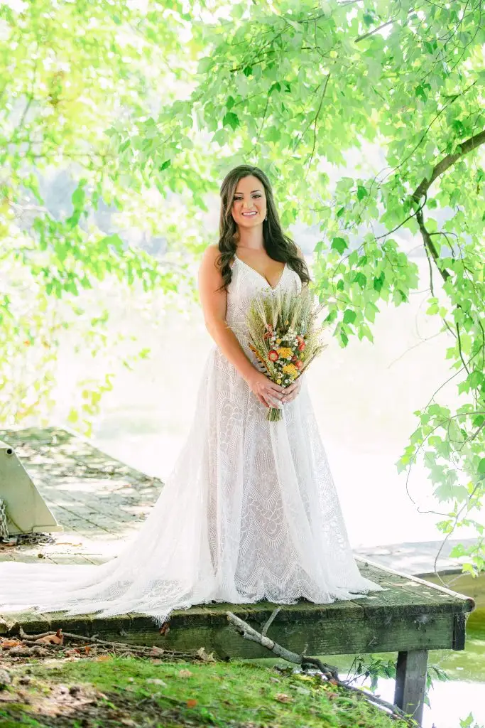 Bride posing by the pond at The Hill wedding venue in Hudson, NY​