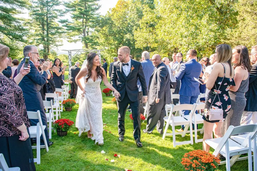 Bride and groom walking down the aisle after ceremony at The Hill, Hudson, NY​