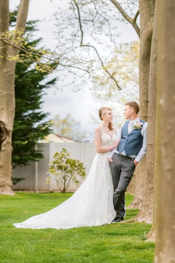 Newlyweds sharing a gaze in the garden of Stewart Manor Country Club​