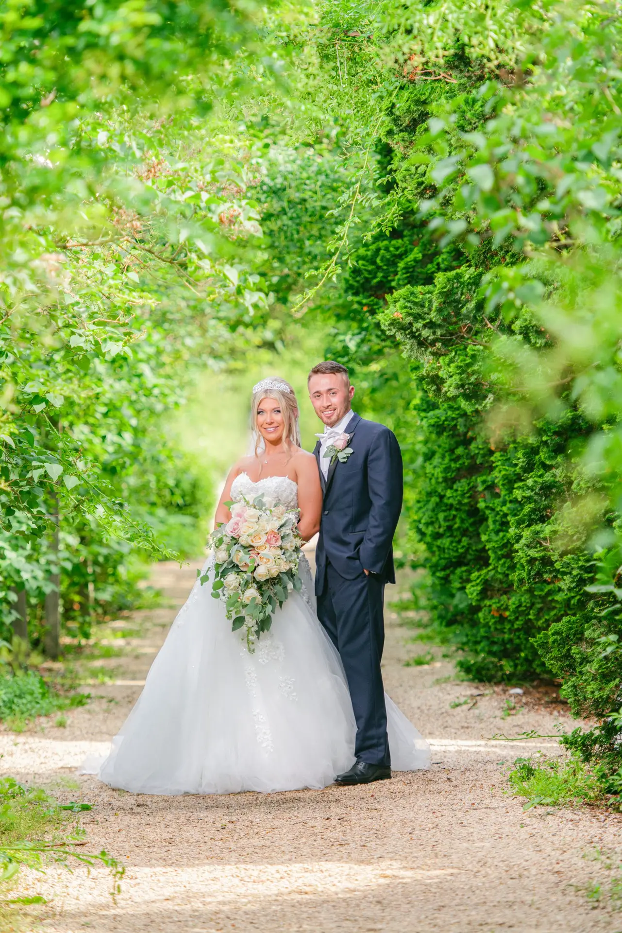 Couple beneath garden arches at Planting Fields Arboretum