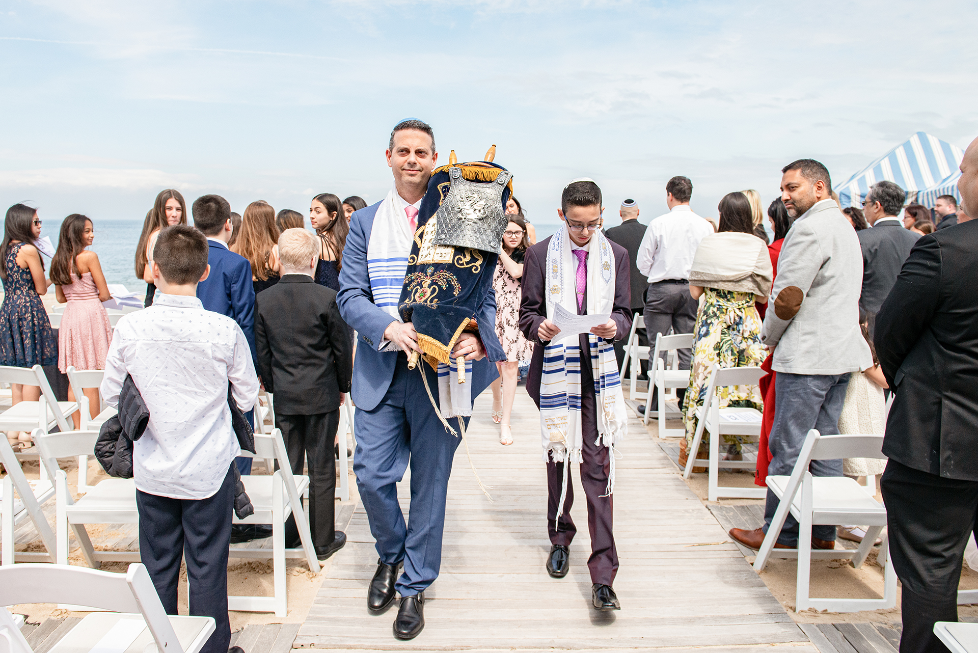 Bar mitzvah processional walking with Torah at Crescent Beach Club Long Island ceremony