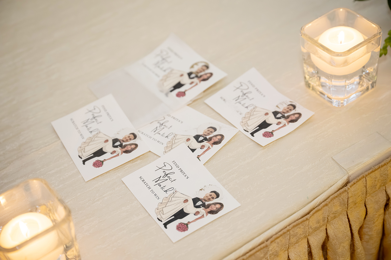 Engagement party detail shot - wedding invitation flatlay with candle and flowers at Leonard's Palazzo Great Neck - Long Island event photographer