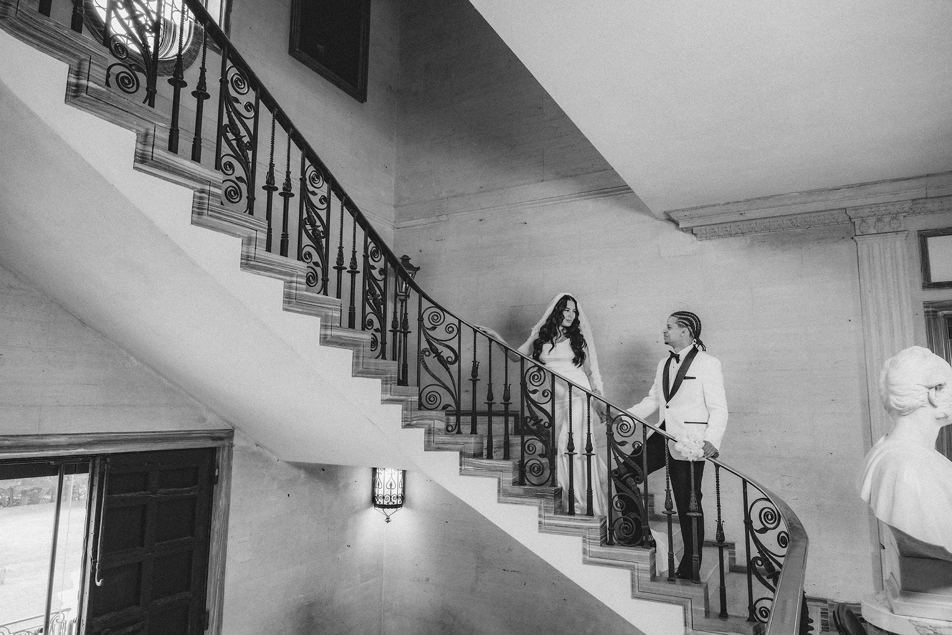 Classic black and white wedding portrait on grand staircase at Vanderbilt Museum