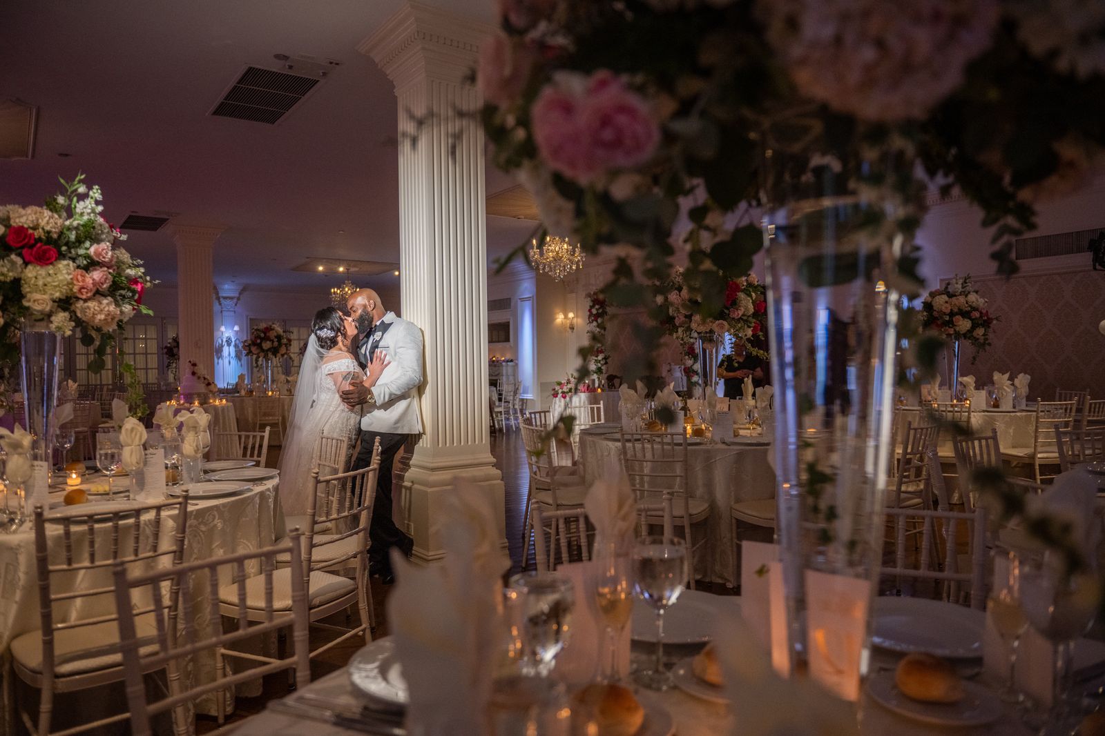 Bride and groom share a moment in the ballroom at The Royalton Mansion
