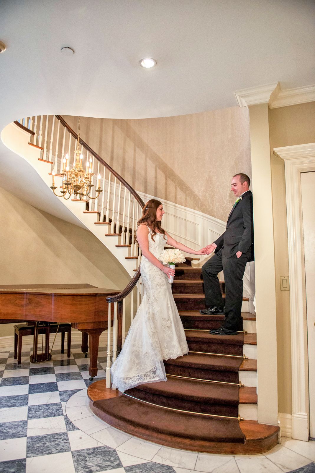 Bride and groom on the grand staircase at The Royalton Mansion