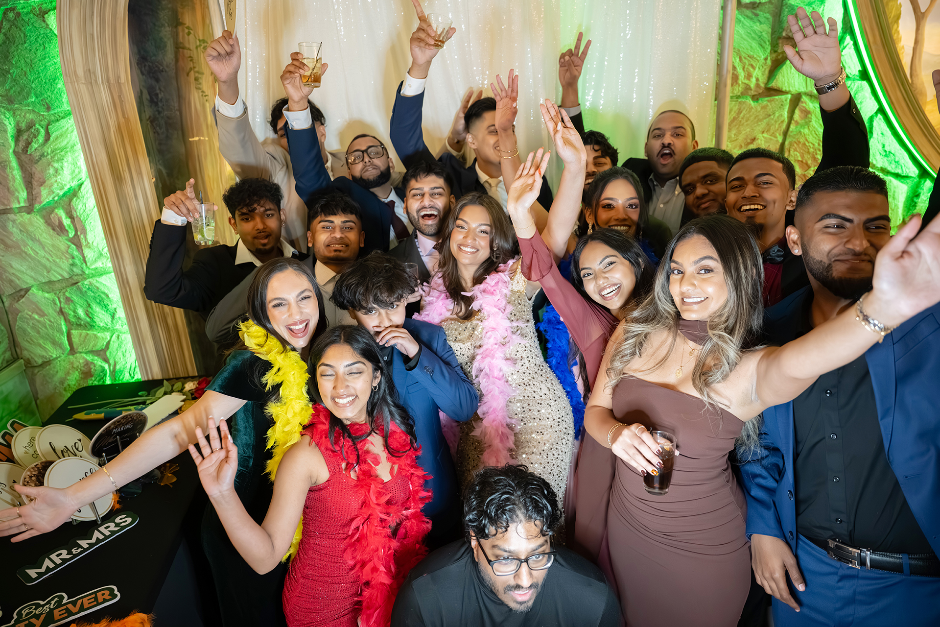 Guests laughing together in the open-air glam photo booth at a Long Island reception