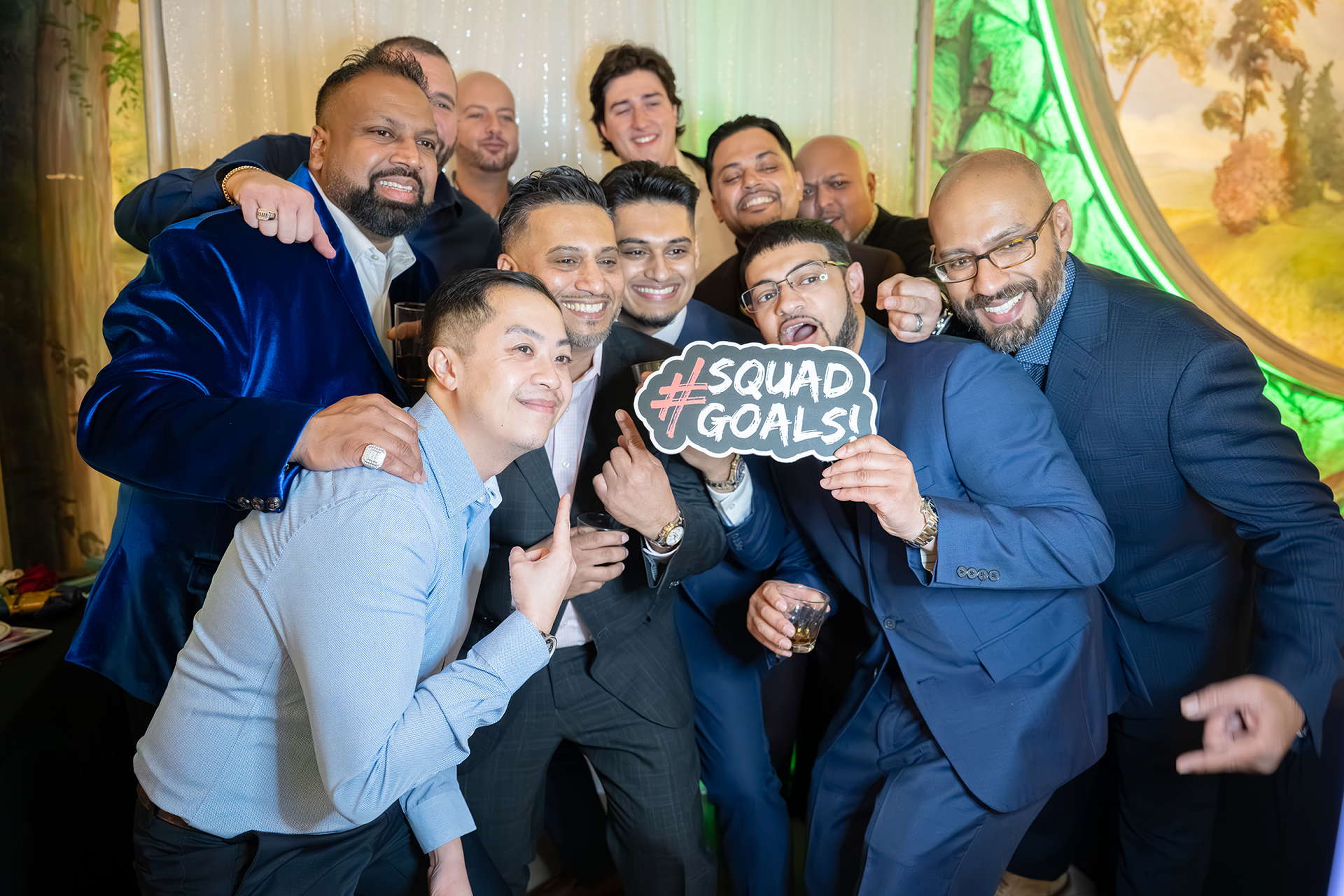 A fun group of friends posing together in the glam photo booth
