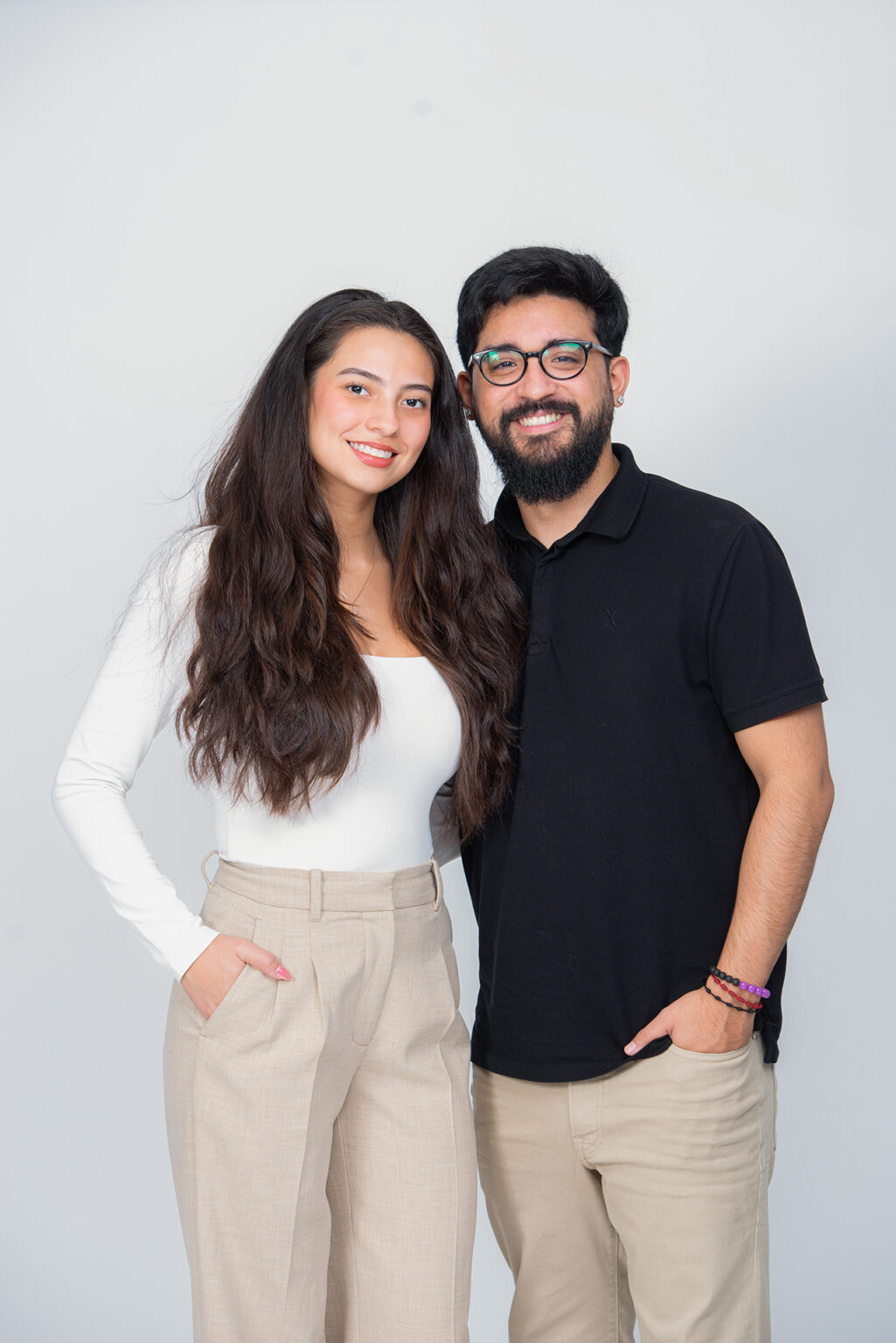 Adult brother and sister smiling together during a professional studio portrait session on Long Island.